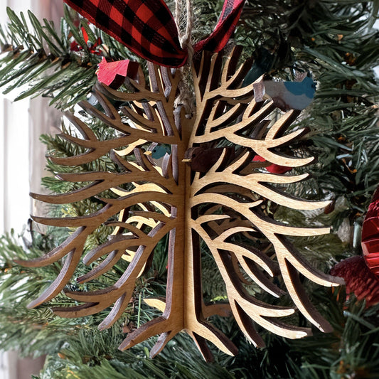 Wooden tree-shaped ornament on a Christmas tree.