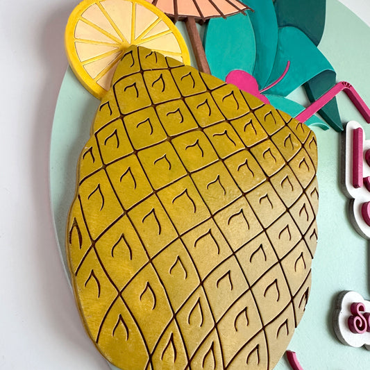 Pineapple-shaped cookie with lemon slice and umbrella on a light blue background
