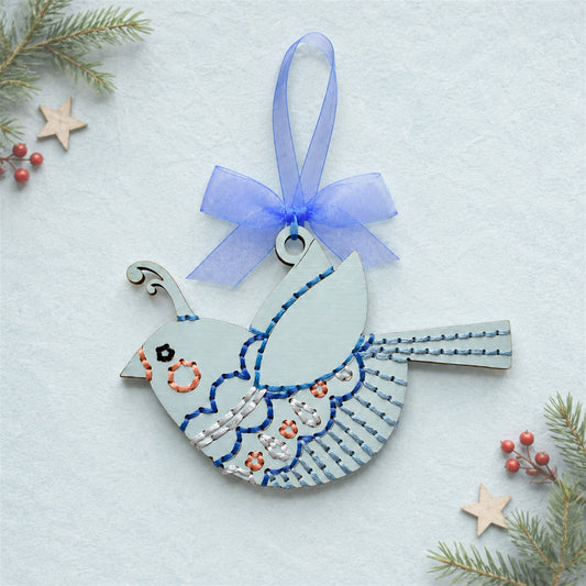 Whimsical songbird embroidery ornament, pale blue painted wood bird with blue stitching and a blue ribbon
