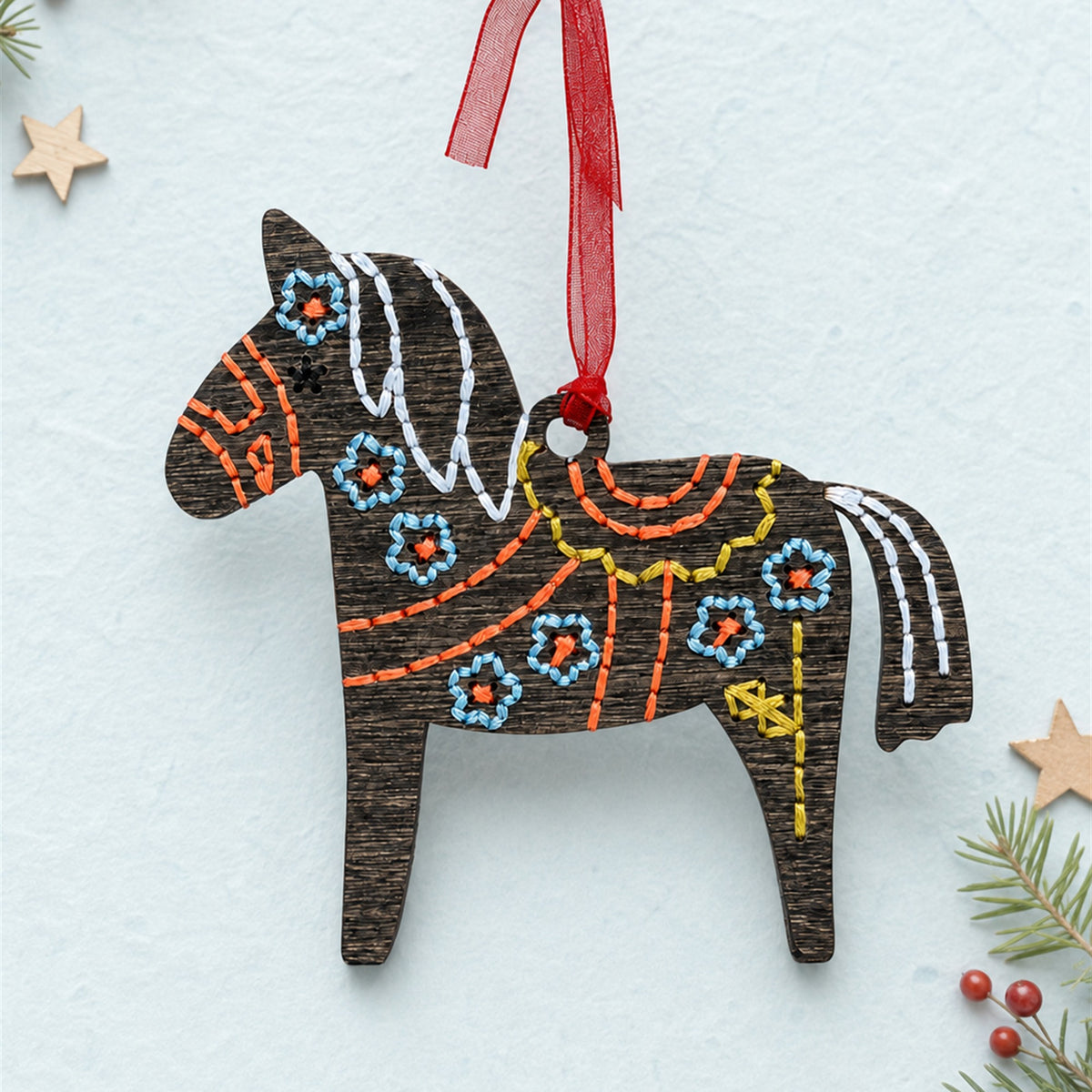 Dala horse embroidery ornament, dark stained wood Swedish horse with colorful folk stitching and a red ribbon