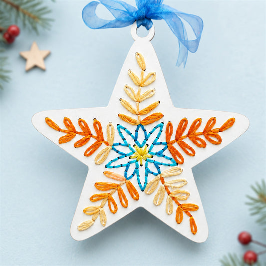 Folk art star embroidery ornament, laser cut wood star with hand stitched embroidery and a ribbon hanger