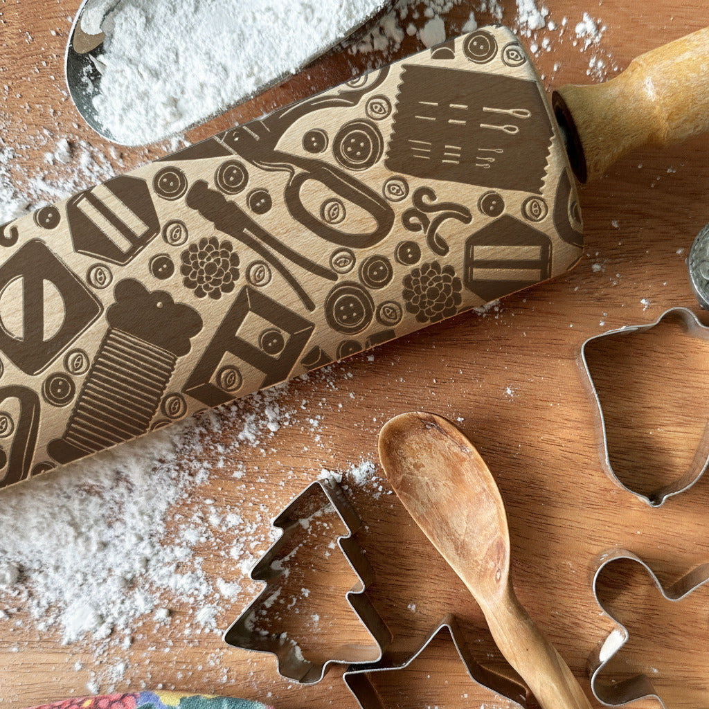 Wooden rolling pin and cookie cutters with flour on a wooden surface, featuring 'Pickle and Peach Studio' branding.