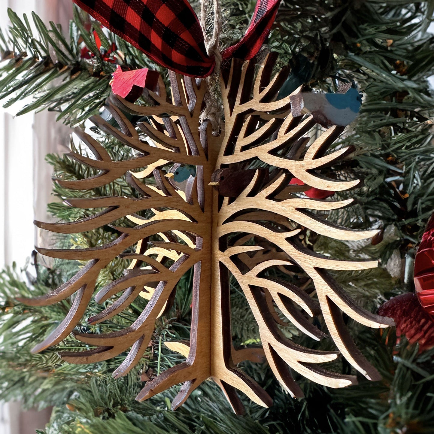 Wooden tree-shaped ornament on a Christmas tree.