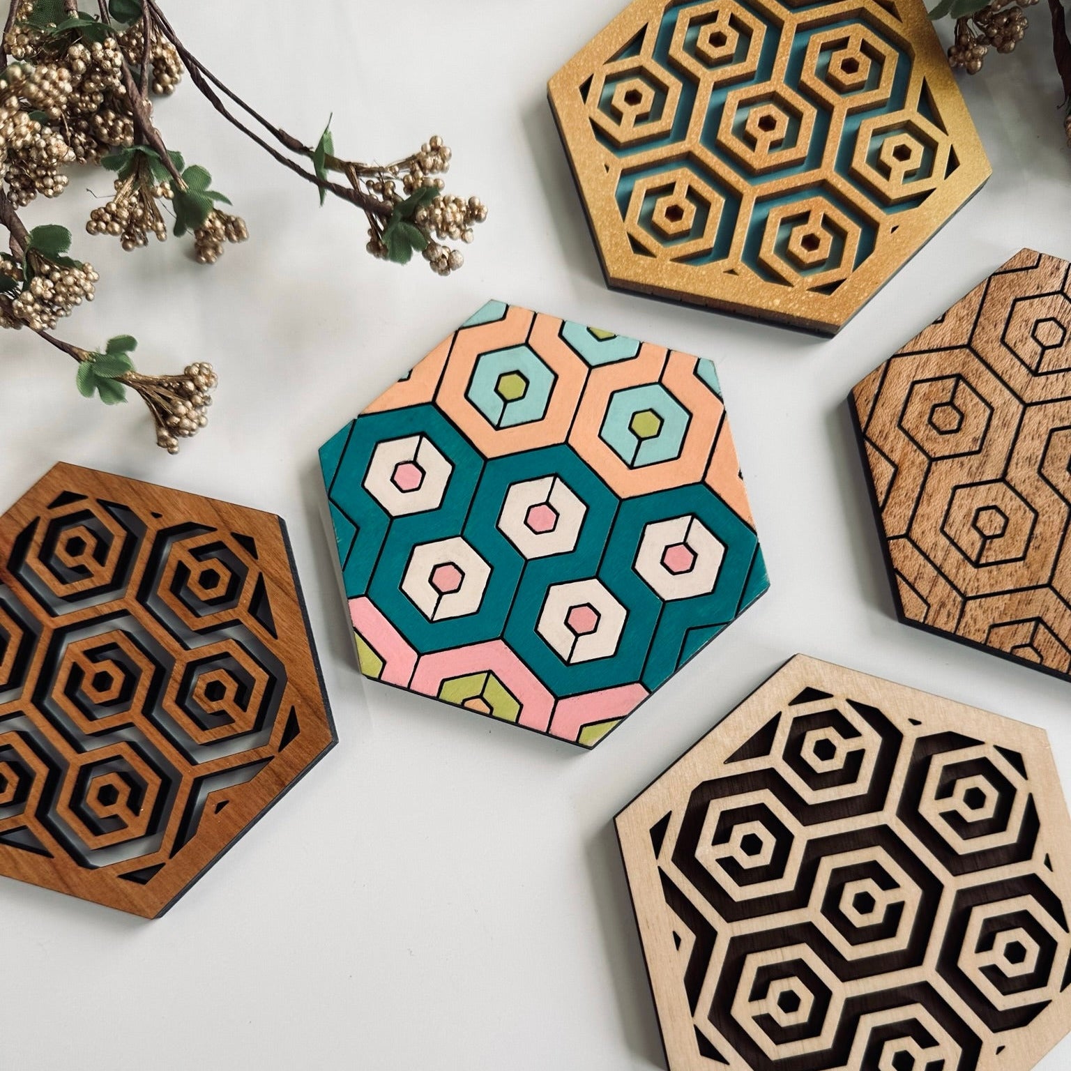 Hexagonal coasters with geometric patterns on a white surface.