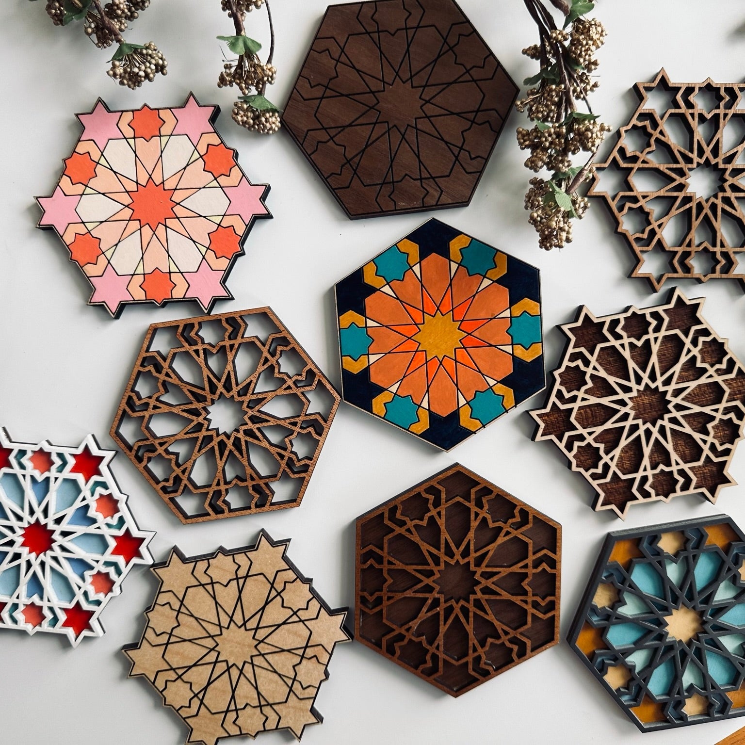 Hexagonal decorative coasters with geometric patterns on a white background