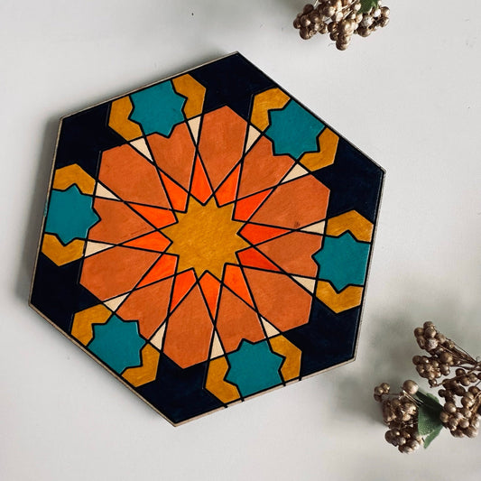 Hexagonal decorative coaster with geometric pattern on a white surface