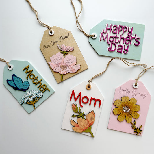 Decorative Mother's Day gift tags with floral designs and text on a white background
