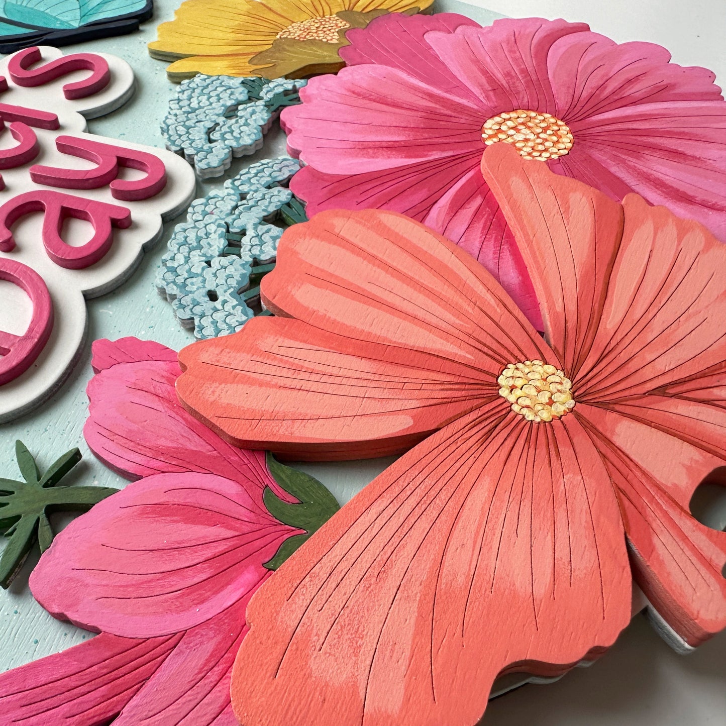 Colorful paper flowers and 'Happy Mother's Day' text on a white background