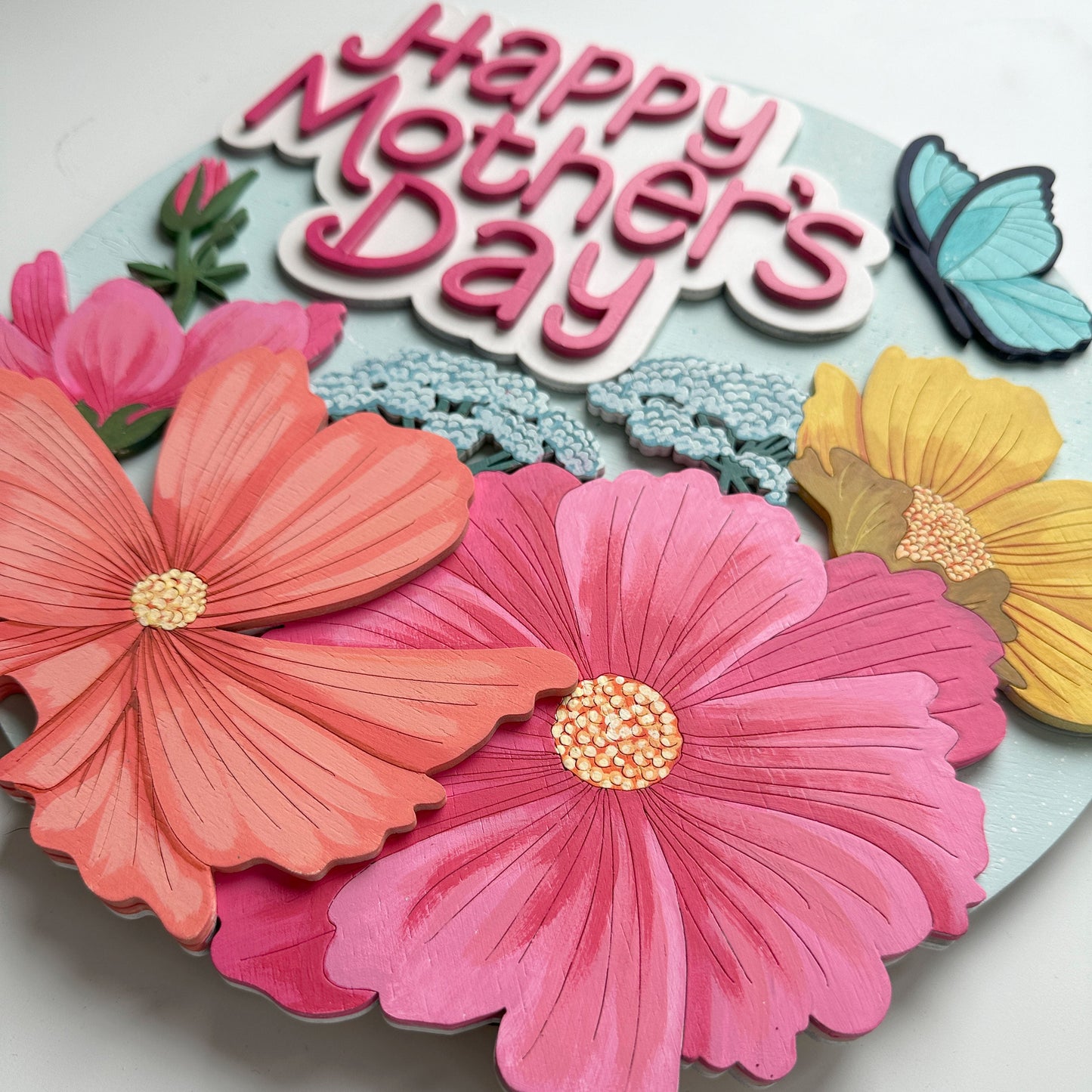 Colorful 'Happy Mother's Day' card with flowers and butterflies on a light background