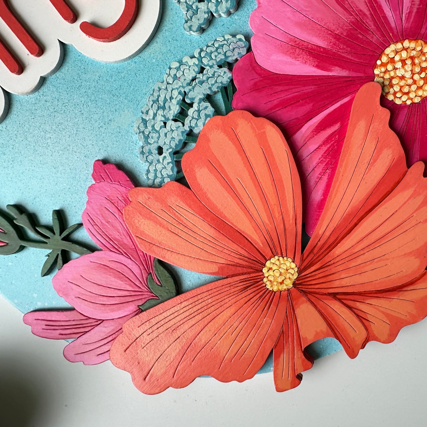 Decorative paper flowers on a light blue background