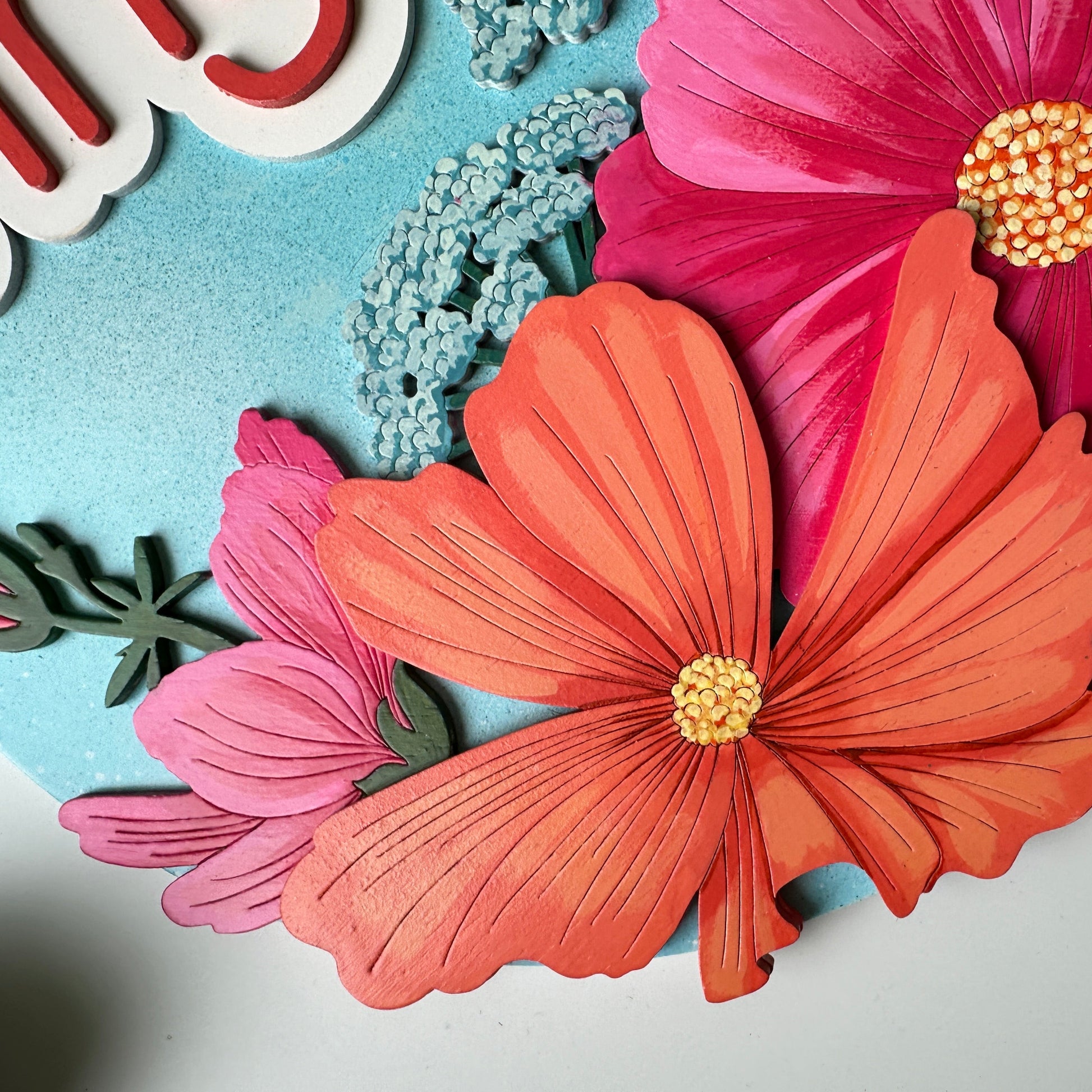 Decorative paper flowers on a light blue background