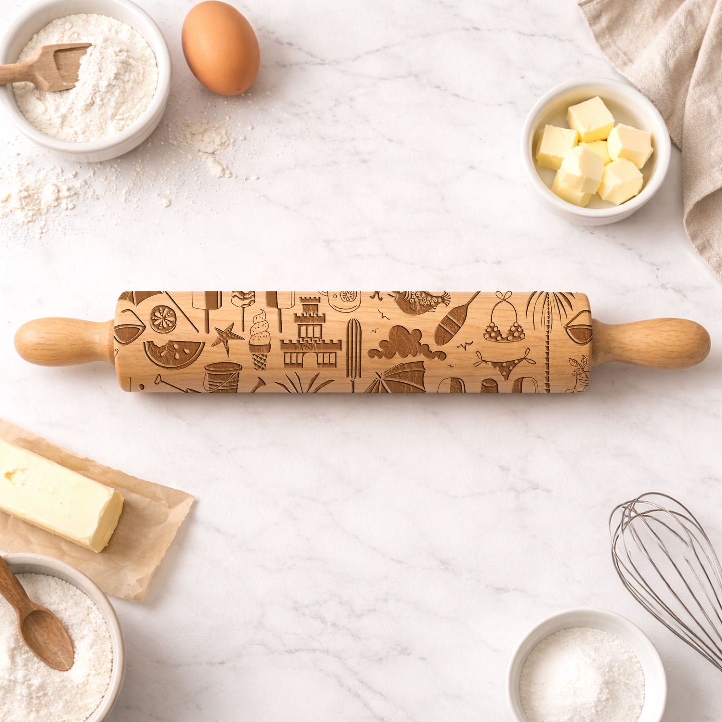 Decorative rolling pin with embossed designs on a kitchen counter with baking ingredients.