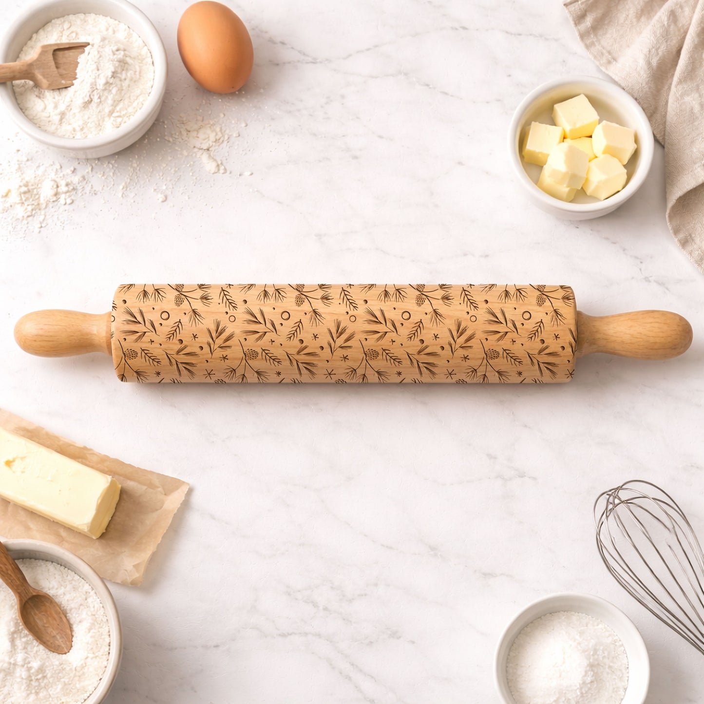 Wooden rolling pin with snowflake pattern on a kitchen counter with baking ingredients.