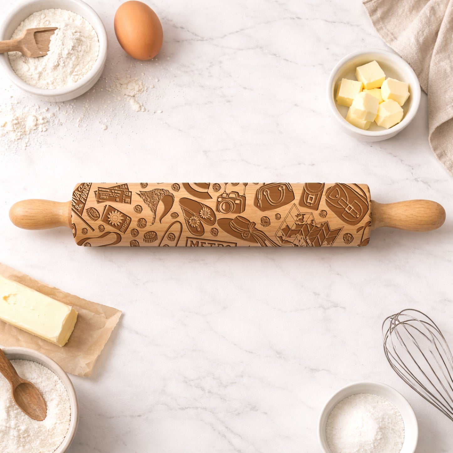 Wooden rolling pin with embossed designs on a kitchen counter with baking ingredients.