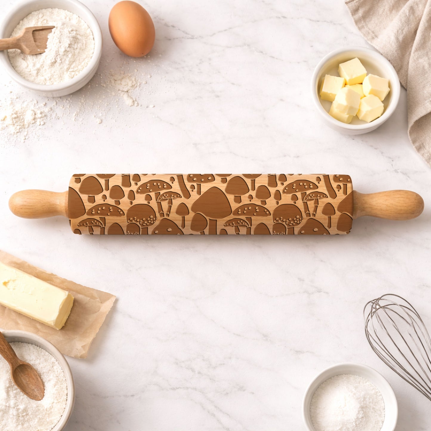 Wooden rolling pin with mushroom pattern on a kitchen counter with baking ingredients.