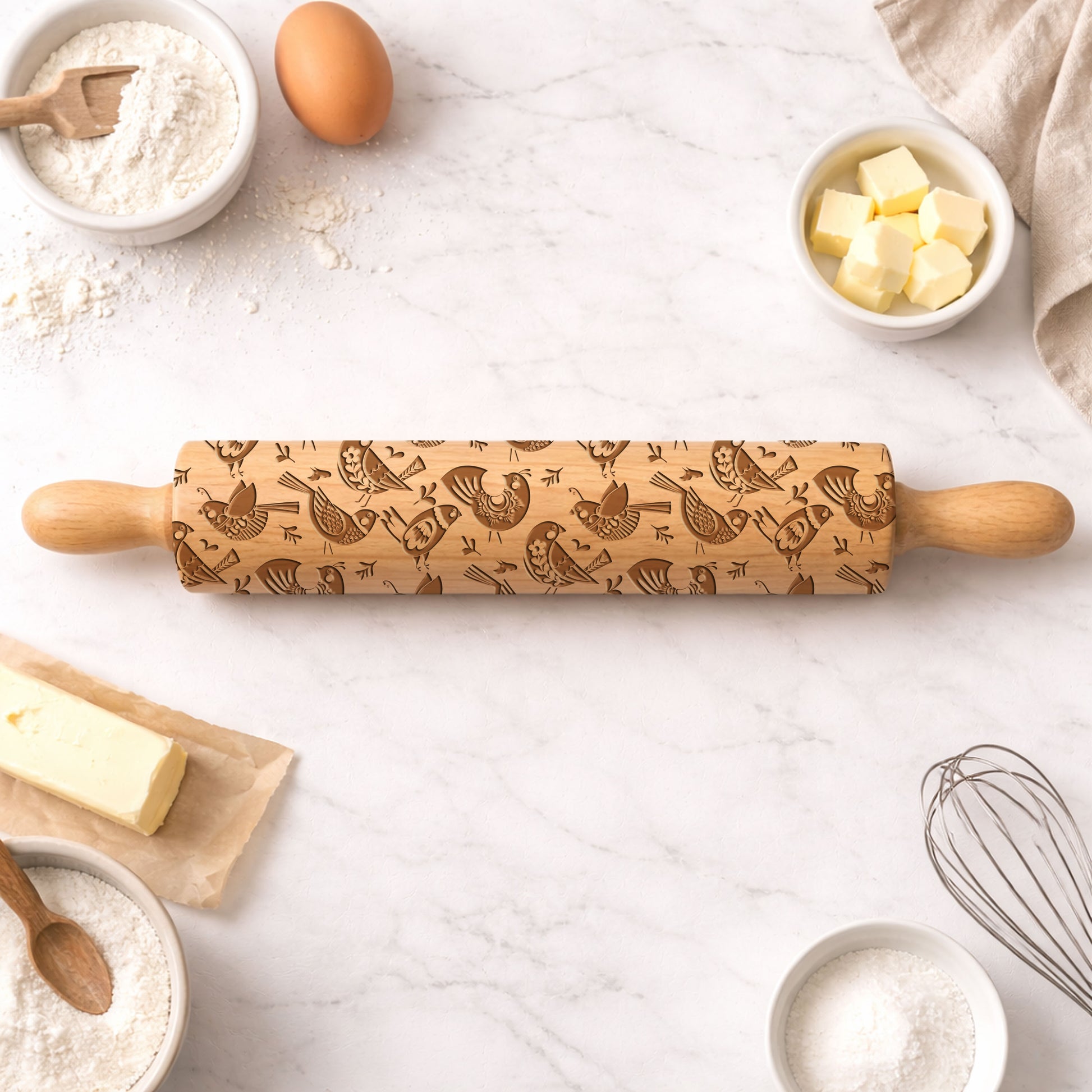 Wooden rolling pin with snowflake pattern on a kitchen counter with baking ingredients.