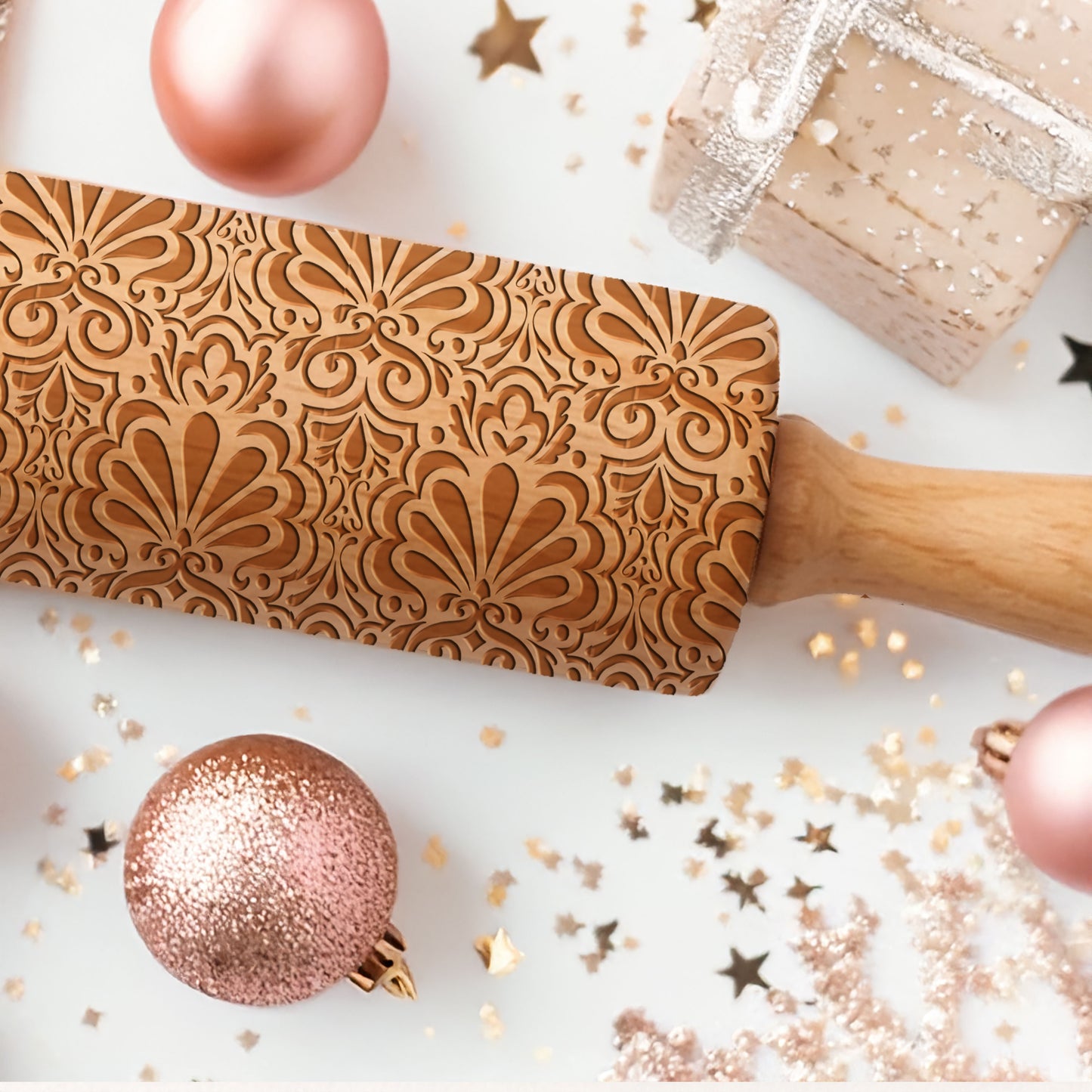 Decorative rolling pin with intricate patterns on a festive background with ornaments and confetti.