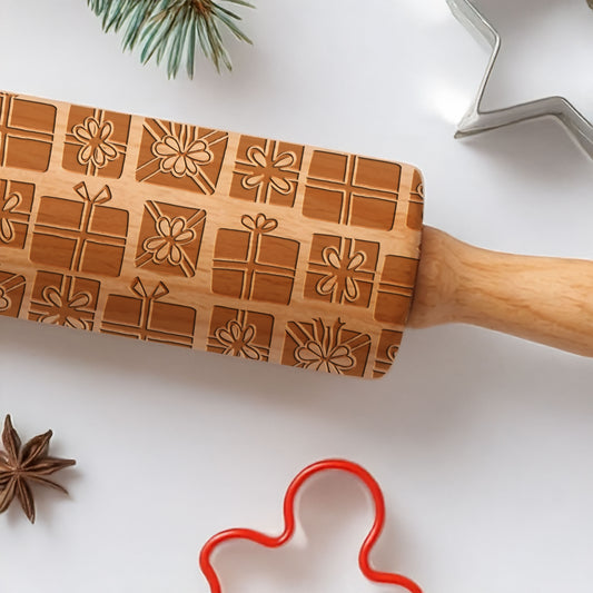 Wooden rolling pin with embossed patterns on a white surface with baking tools.