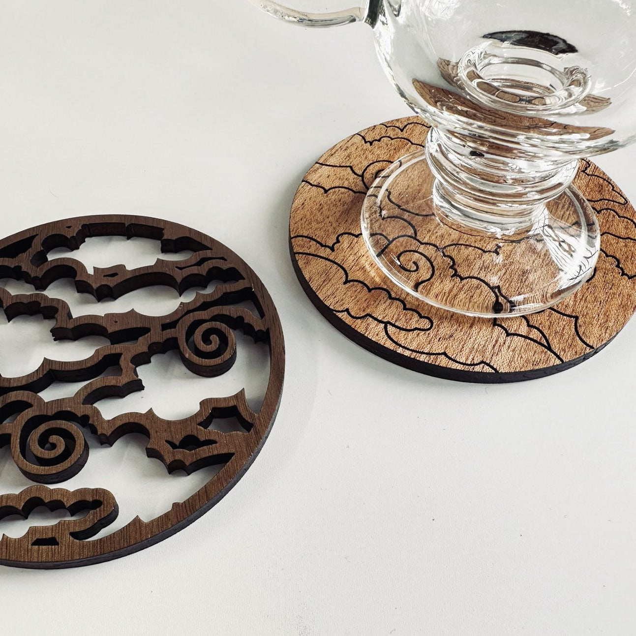 Wooden coasters with intricate designs on a white surface