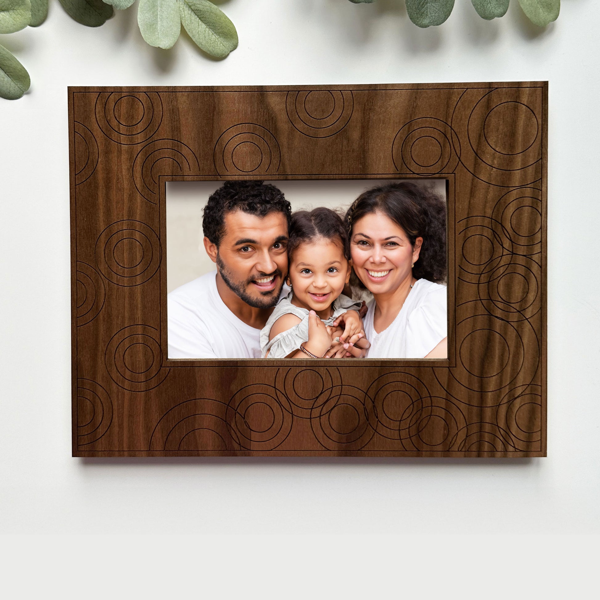 Wooden photo frame with a family portrait on a white background