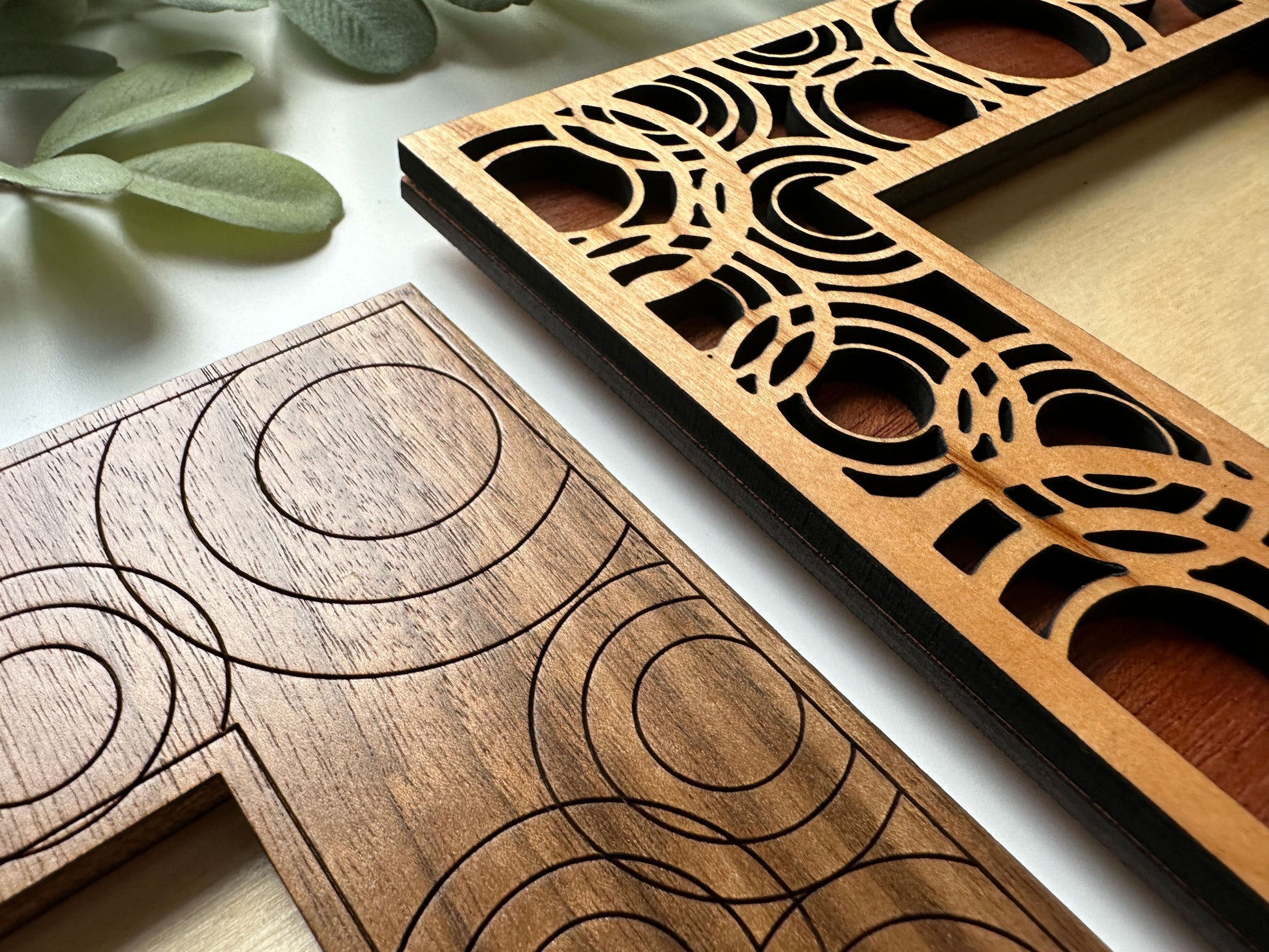 Two wooden puzzle pieces with geometric patterns on a light background