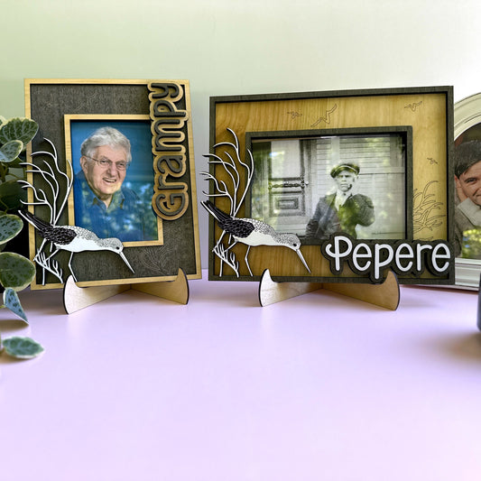 Three decorative photo frames with engraved names and family photos on a light surface.