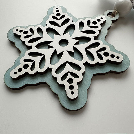 Decorative snowflake ornament with intricate patterns on a light background