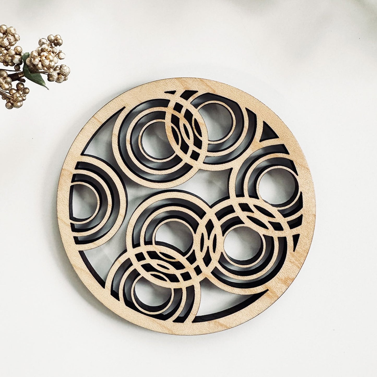 Decorative coaster with circular patterns on a light background