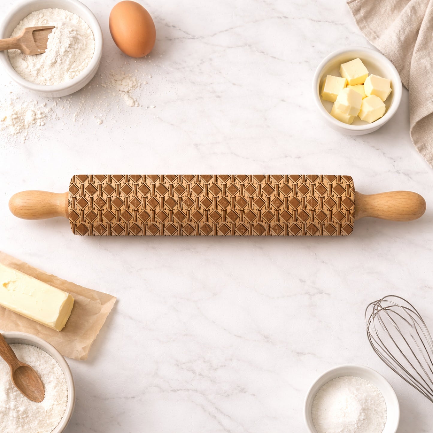Wooden rolling pin with textured design on a kitchen counter with baking ingredients.