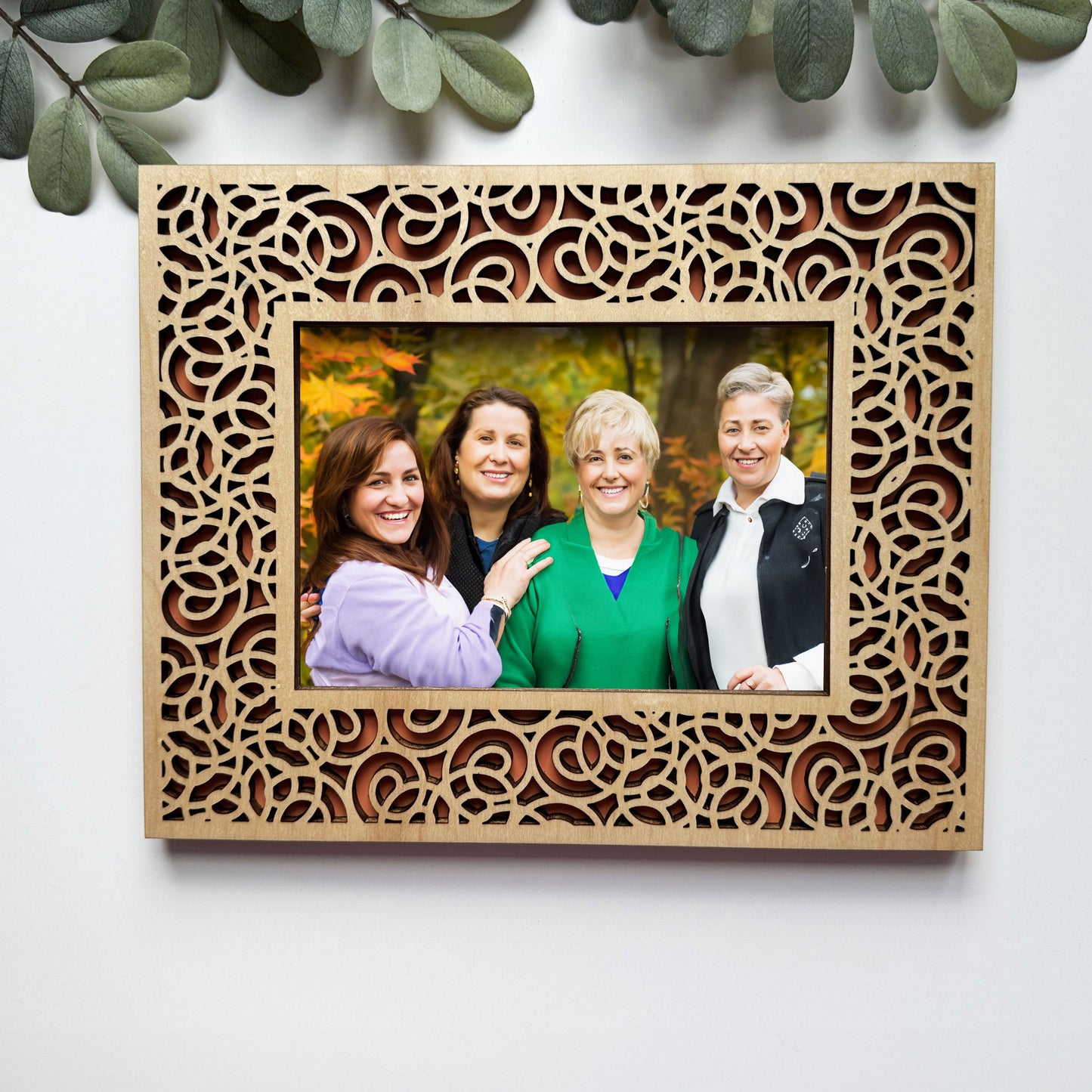 Wooden photo frame with a family portrait on a white background