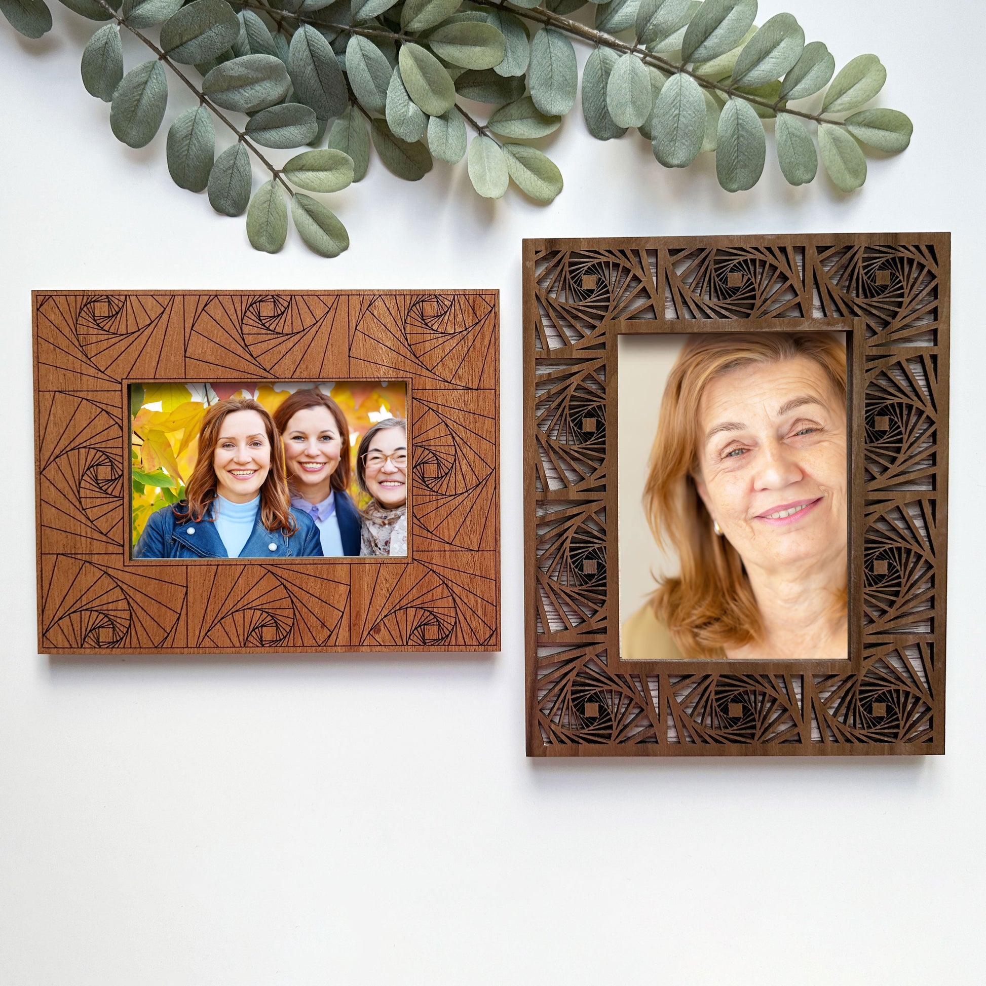 Two wooden picture frames with decorative patterns, one containing a family photo and the other a portrait of an older woman.