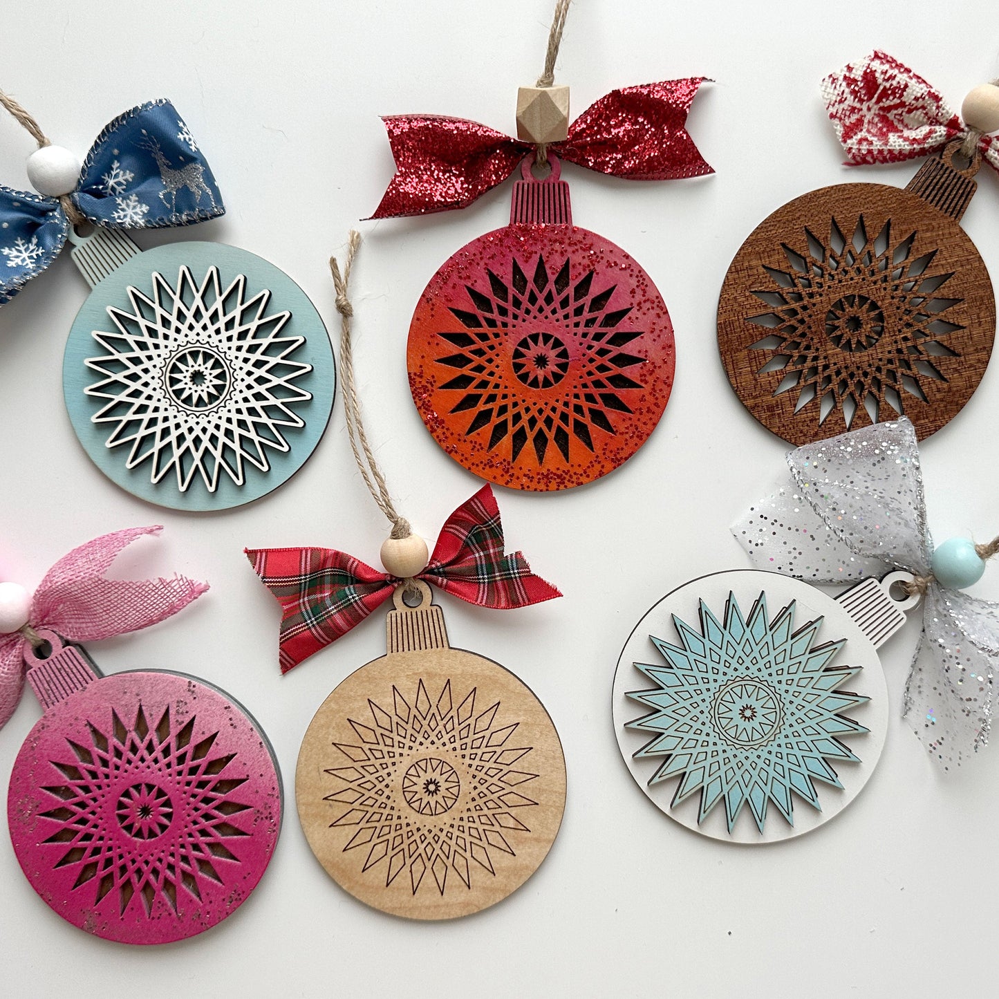 Decorative ornaments with geometric patterns and colorful bows on a white background
