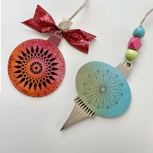 Decorative hanging ornaments with geometric designs on a white background